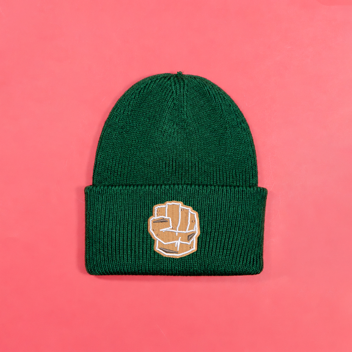 Bottle green knitted beanie with gingerbread-style Hulk fist embroidery on the turned-up cuff.