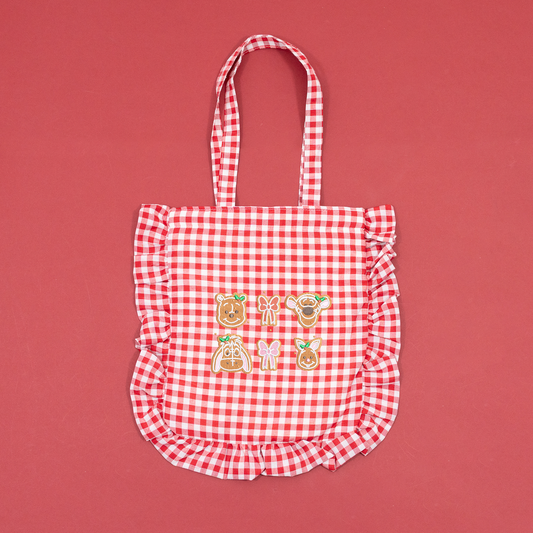Red and white gingham tote bag with ruffled trim and Winnie the Pooh, Tigger, Eeyore and Piglet gingerbread embroidery.